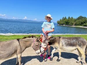 Lisa with the two mini donkeys at Lake Champlain